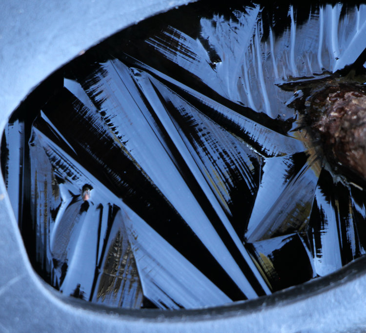 ice patterns on surface of water in watering can