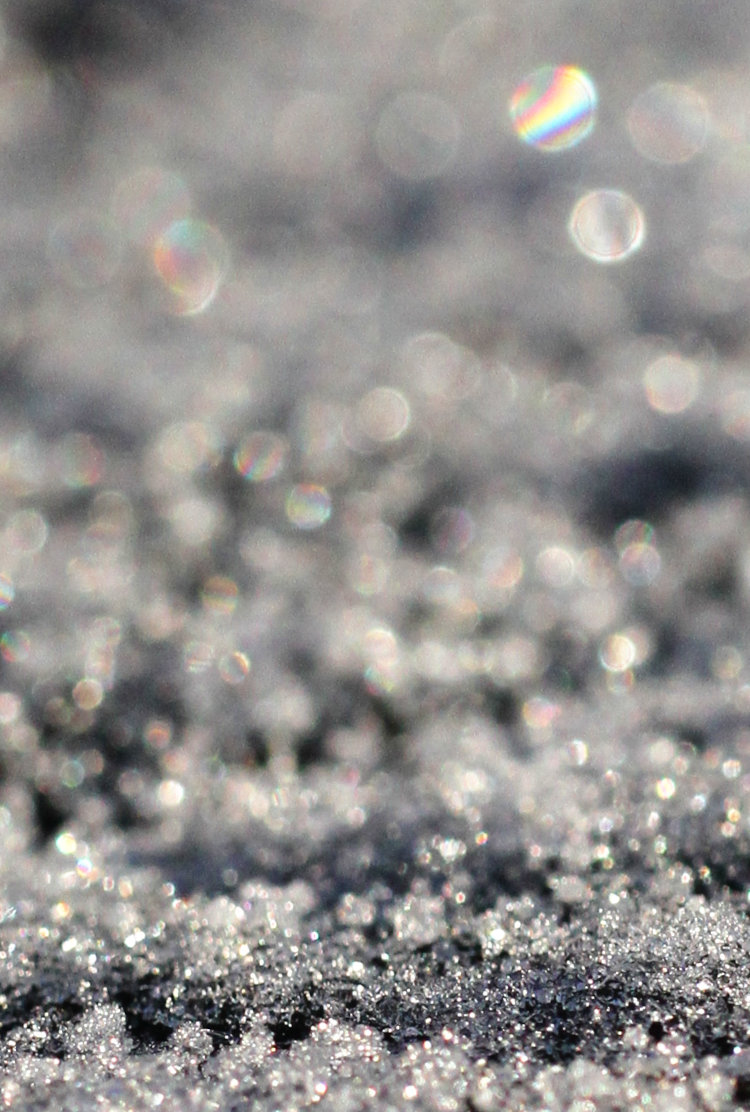 extreme closeup of snow with short depth-of-field and some refraction visible
