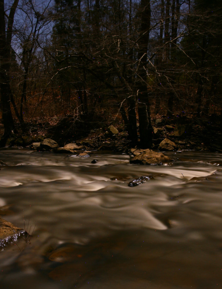 stream rapids by moonlight long exposure