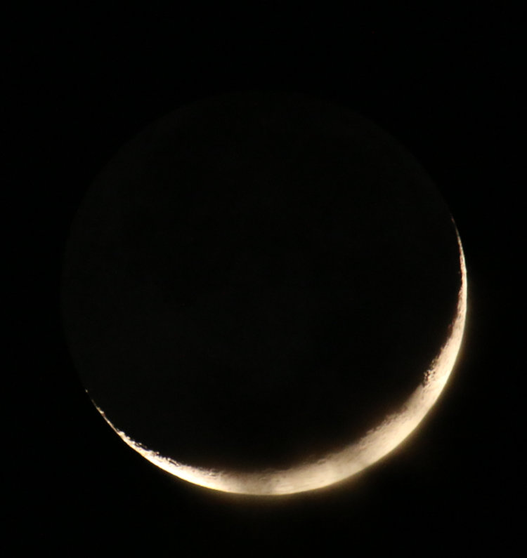 7.4% crescent moon with a hint of clouds