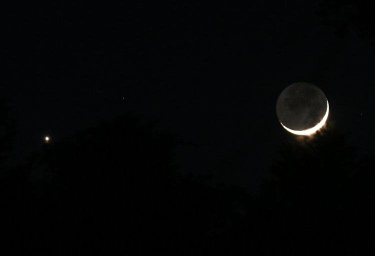 7.4% crescent moon with earthshine, clouds, and Venus nearby