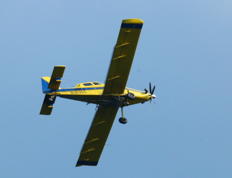 Air Tractor AT-802, registered to NC Geological Survey, passing overhead