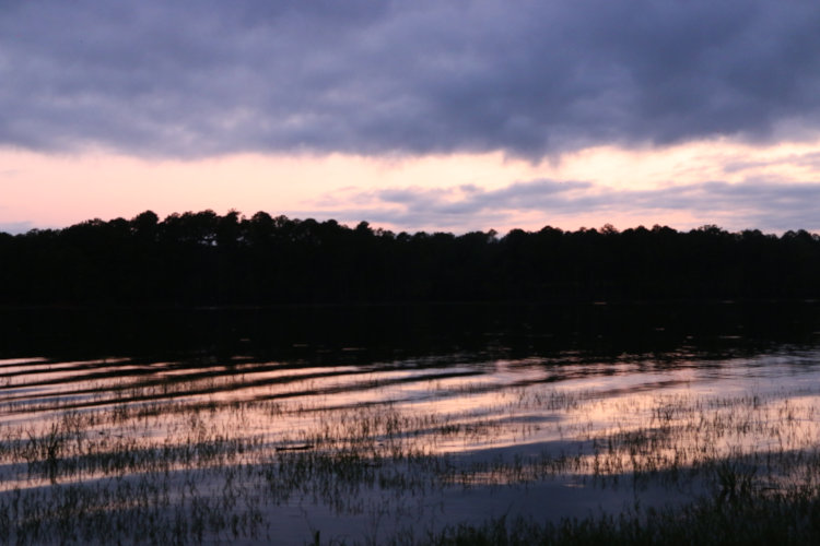bare hints of sunset colors on horizon alongside Jordan Lake