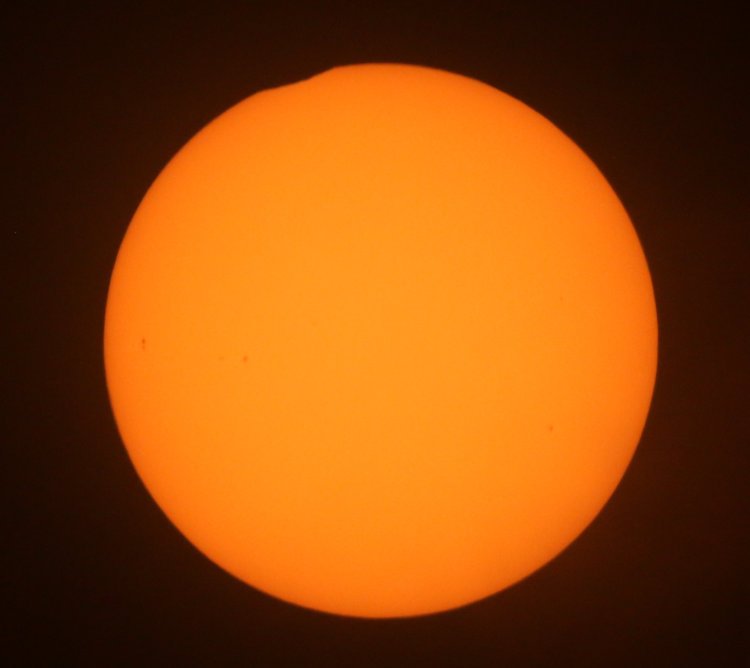 minimal partial solar eclipse roughly 13 minutes before peak, through solar filter