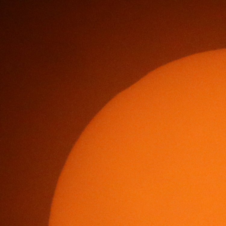 tiny fragment of partial solar eclipse remaining, through solar filter