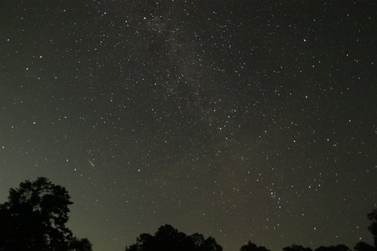 full-frame night exposure showing Milky Way and apparent Perseids meteor