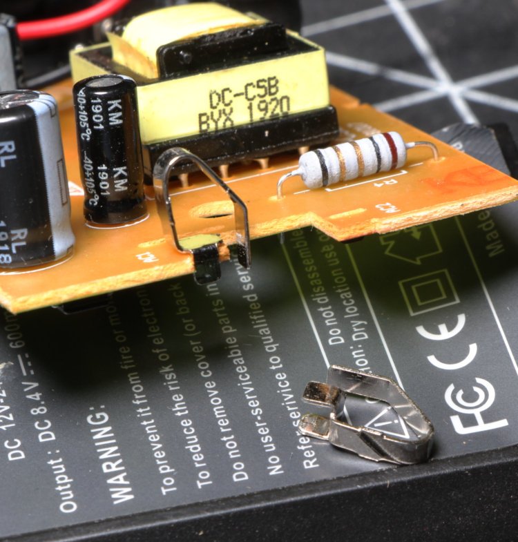disassembled battery charger showing contacts for AC prongs