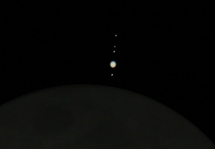 digital composite of Jupiter and Galilean moons above earthshine moon, in exposures to benefit each