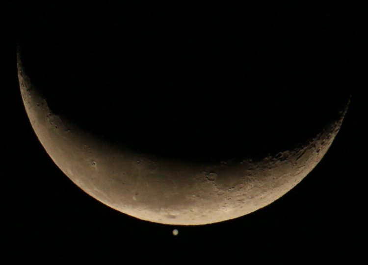 The crescent moon just before occulting Jupiter